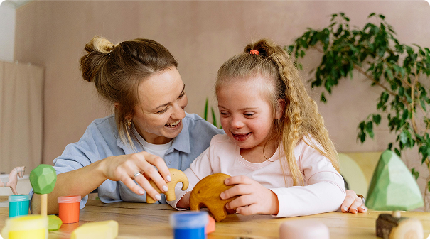 A woman and child laughing as they play with toys