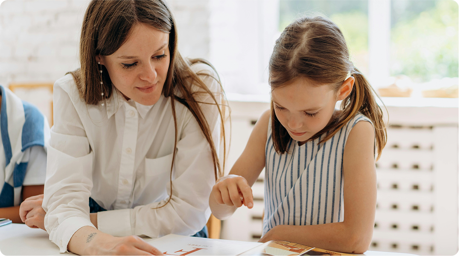 A woman and child reading a book