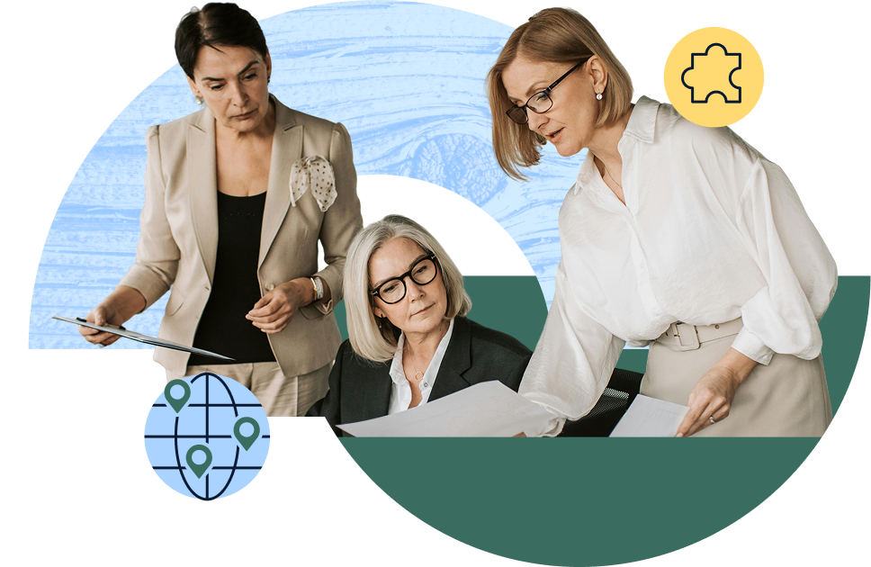 Three women in business attire reviewing documents. A puzzle piece icon and world icon sit in the corners of the image.